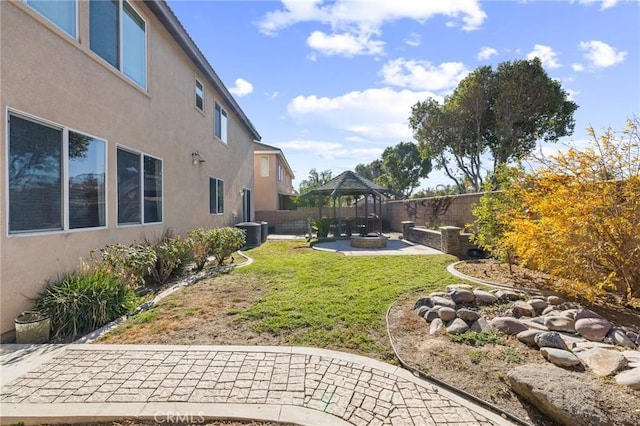 view of yard featuring a gazebo and an outdoor fire pit