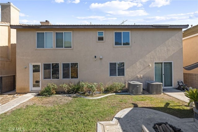 rear view of house featuring a yard and central AC unit