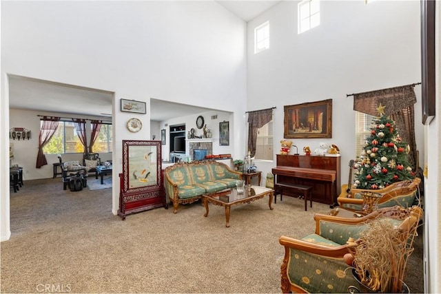 living room featuring carpet floors and a high ceiling