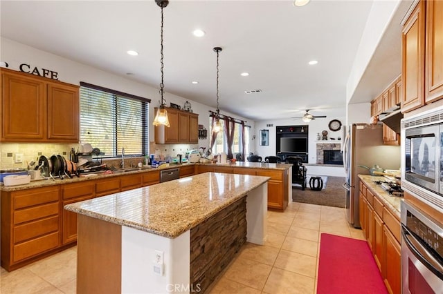 kitchen featuring pendant lighting, sink, a wealth of natural light, and ceiling fan