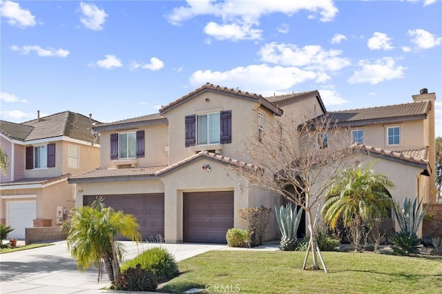 mediterranean / spanish home with a garage and a front yard