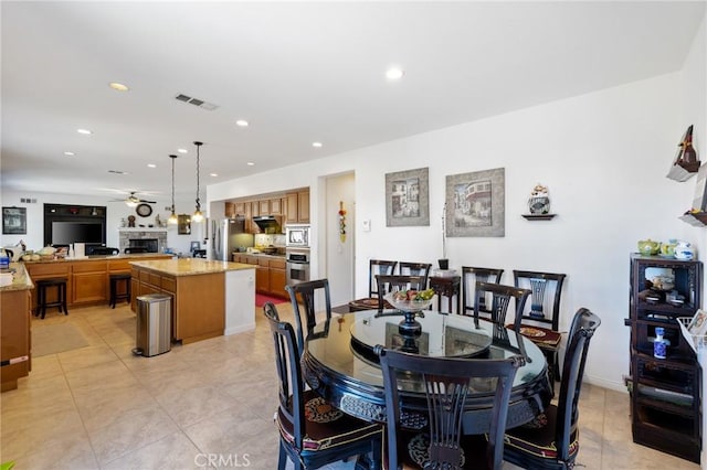 dining area featuring ceiling fan and light tile patterned floors