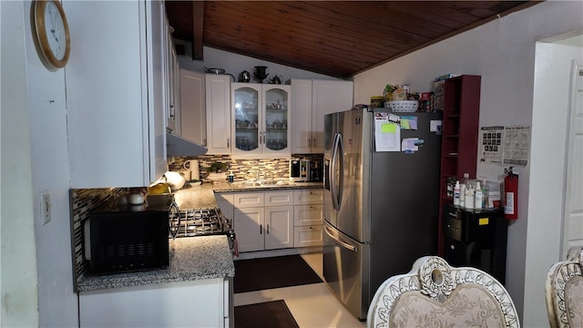 kitchen featuring stainless steel appliances, white cabinetry, lofted ceiling, and wood ceiling