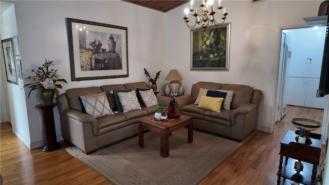 living room with light wood-type flooring and a chandelier