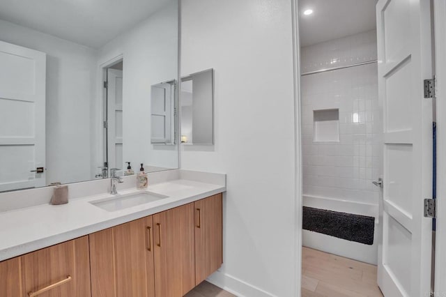 full bathroom with vanity and baseboards