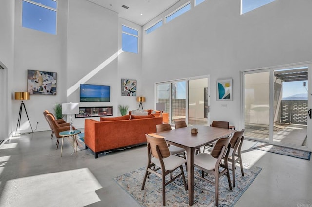 dining area featuring concrete flooring and visible vents