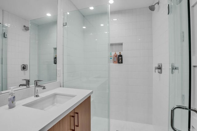 full bath with a shower stall and vanity