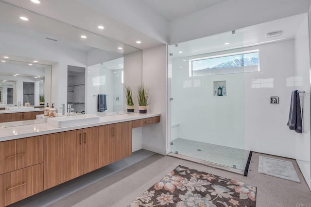 full bath with recessed lighting, vanity, and a walk in shower