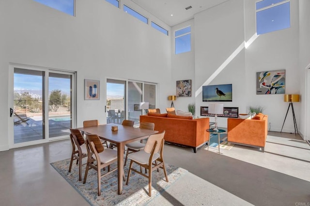 dining space with visible vents and finished concrete flooring