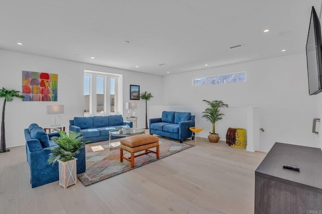 living area featuring light wood-style flooring, visible vents, and recessed lighting