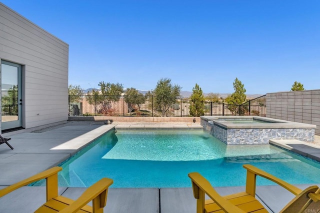 view of pool with a fenced backyard, a pool with connected hot tub, and a patio