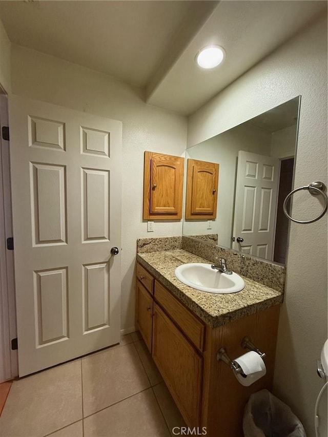 bathroom featuring tile patterned floors, toilet, and vanity