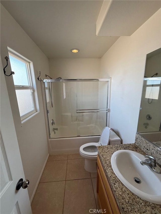 full bathroom with vanity, combined bath / shower with glass door, tile patterned floors, and toilet