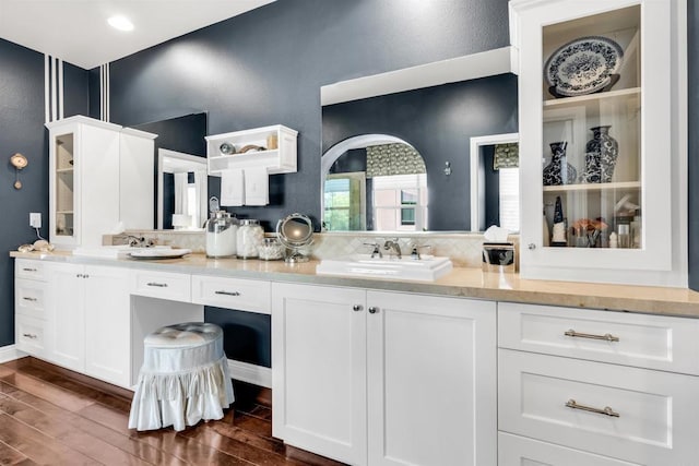 bathroom featuring decorative backsplash, vanity, and wood-type flooring