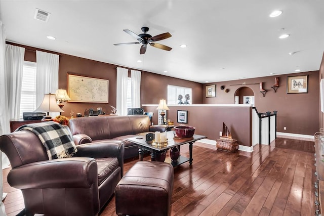 living room with dark hardwood / wood-style flooring and ceiling fan