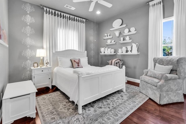 bedroom with dark hardwood / wood-style floors and ceiling fan