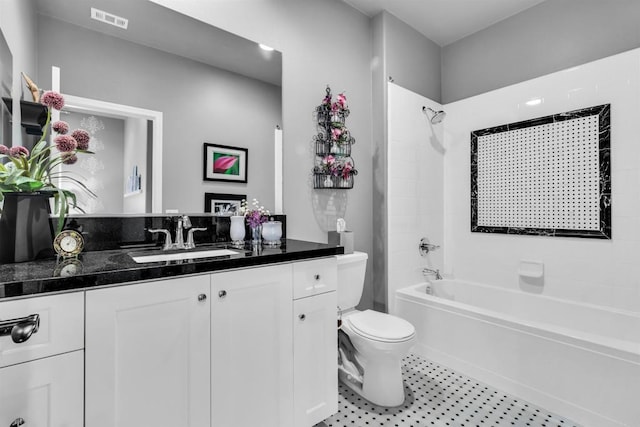 full bathroom featuring toilet, vanity, and tiled shower / bath