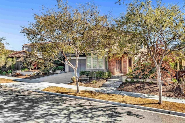 view of property hidden behind natural elements featuring a garage