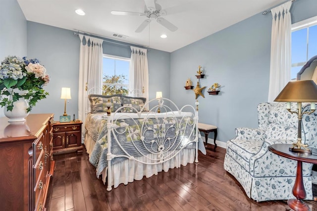 bedroom with dark hardwood / wood-style flooring, multiple windows, and ceiling fan