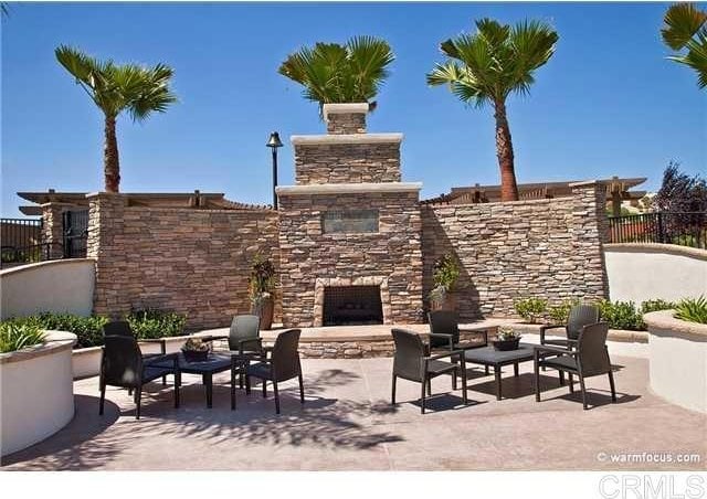 view of patio / terrace with an outdoor stone fireplace