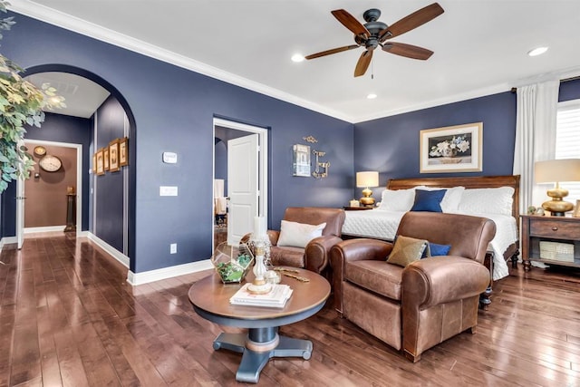 bedroom with dark hardwood / wood-style flooring, ceiling fan, and crown molding