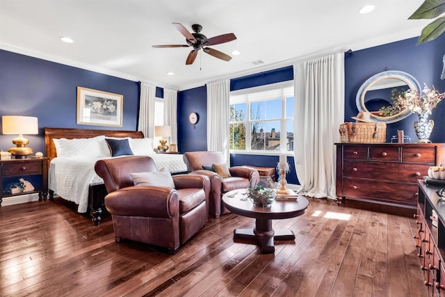 bedroom featuring hardwood / wood-style flooring, ceiling fan, and crown molding