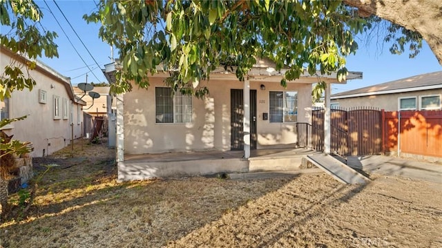 rear view of property featuring a porch