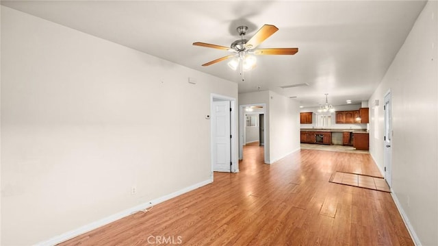 unfurnished living room featuring ceiling fan and light hardwood / wood-style floors