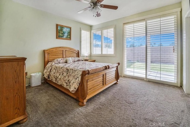 bedroom with dark colored carpet, ceiling fan, and access to exterior