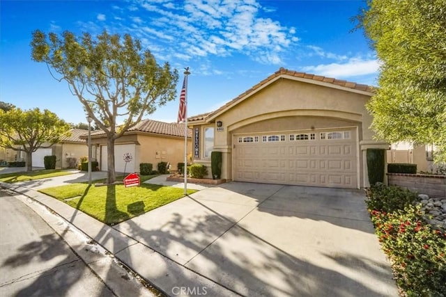 view of front of home featuring a front yard and a garage