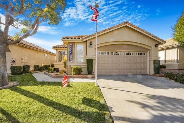 view of front of home featuring a garage and a front yard