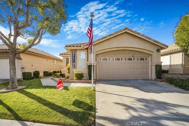 view of front of house featuring a garage and a front lawn