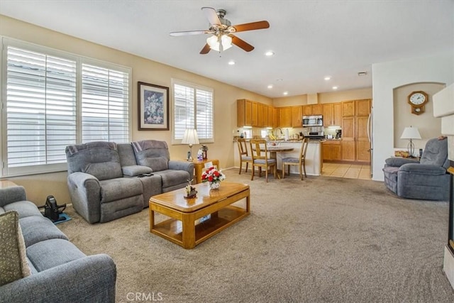 carpeted living room with ceiling fan and sink