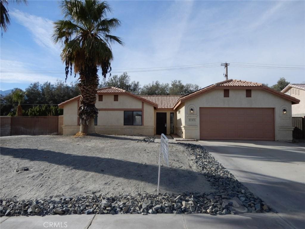 mediterranean / spanish house featuring a garage