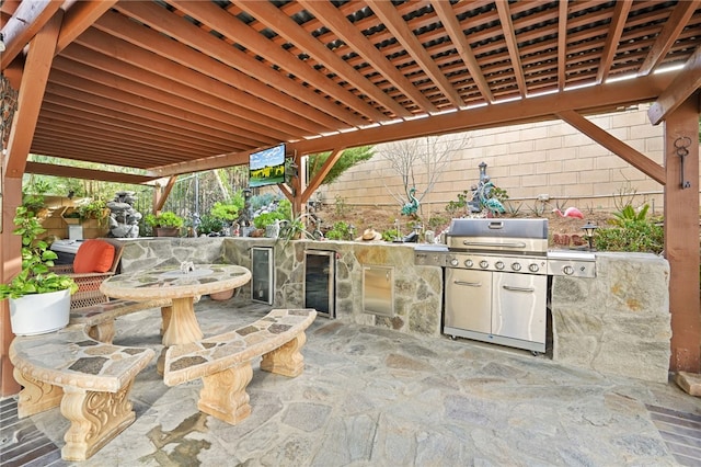 view of patio / terrace with an outdoor kitchen, wine cooler, and grilling area