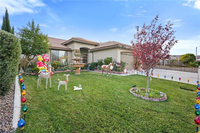 mediterranean / spanish home with a front yard and a garage