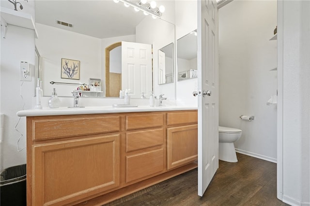 bathroom with vanity, hardwood / wood-style flooring, and toilet