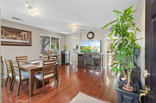 dining room with a fireplace and hardwood / wood-style flooring