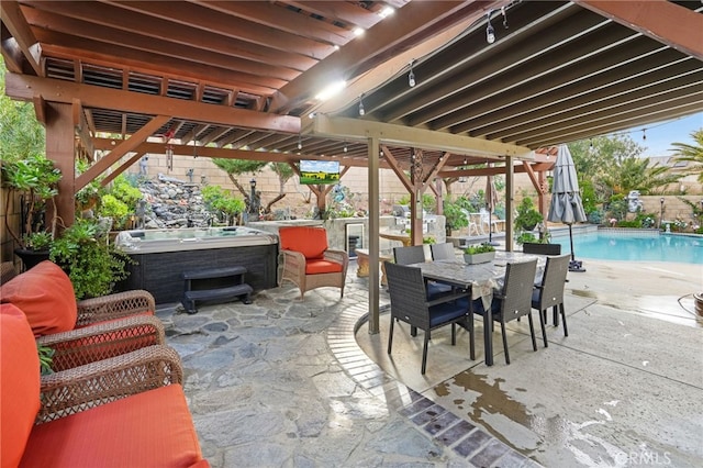 view of patio / terrace featuring a pool with hot tub