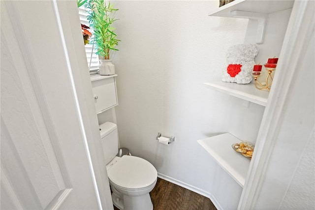 bathroom with hardwood / wood-style floors and toilet