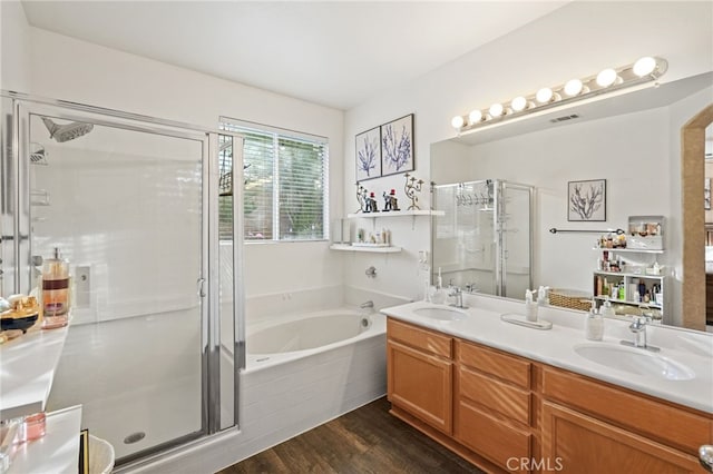 bathroom featuring shower with separate bathtub, vanity, and hardwood / wood-style flooring