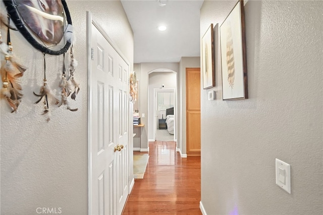 corridor with light hardwood / wood-style floors