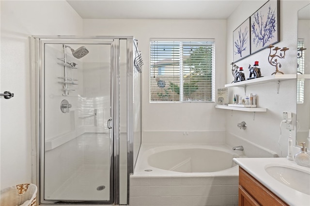 bathroom with vanity and shower with separate bathtub