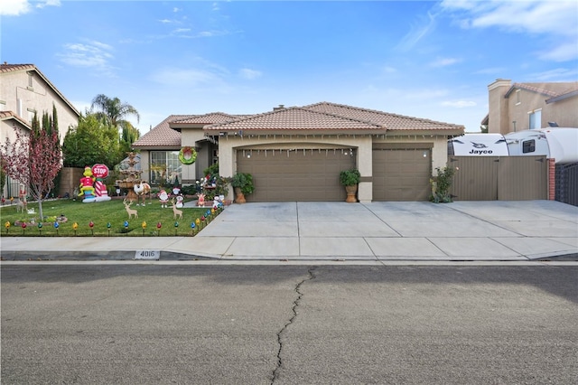 mediterranean / spanish house with a garage and a front yard