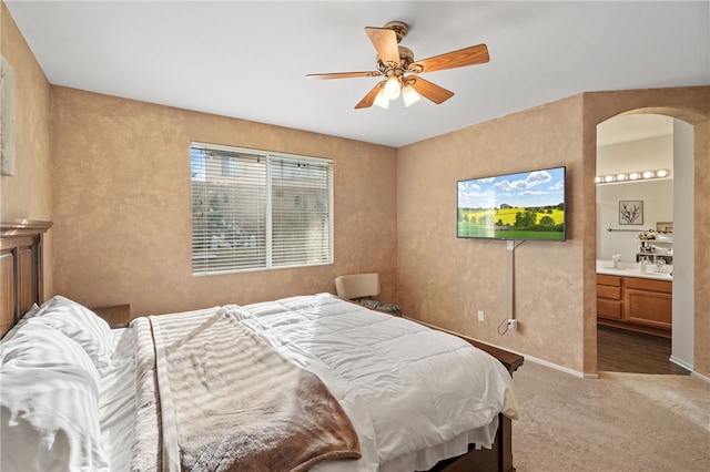 bedroom with carpet flooring, ensuite bath, and ceiling fan