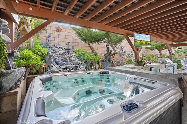 view of patio / terrace with a hot tub