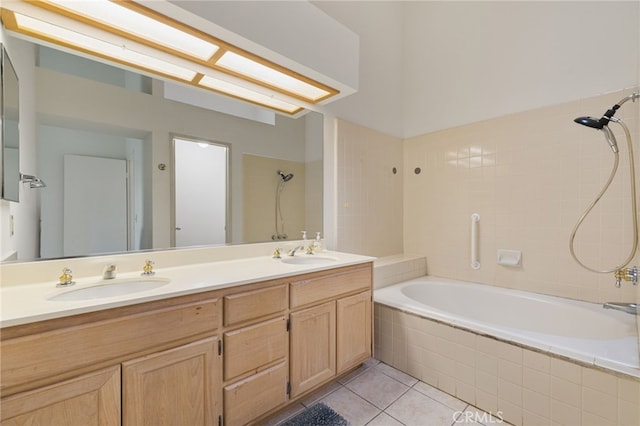 bathroom with tile patterned flooring, vanity, and tiled shower / bath combo