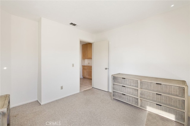 unfurnished bedroom featuring light colored carpet