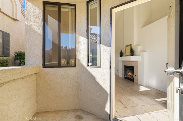 exterior space with tile patterned floors and a tiled fireplace