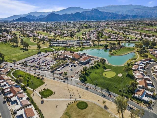 birds eye view of property with a water and mountain view